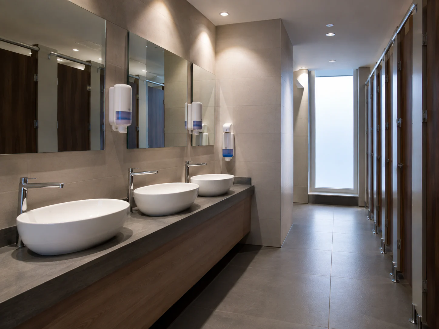 Commercial washroom cleaned and restocked